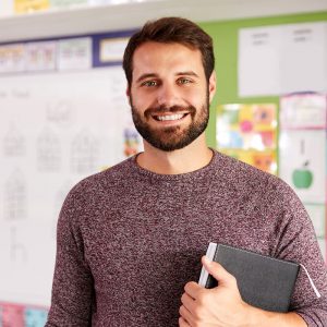 portrait-of-male-elementary-school-teacher-standin-FHS34DB.jpg