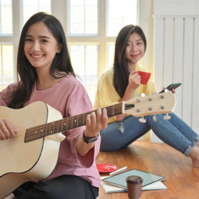 teenage-girls-are-singing-and-playing-guitars-they-NJUHDBF.jpg